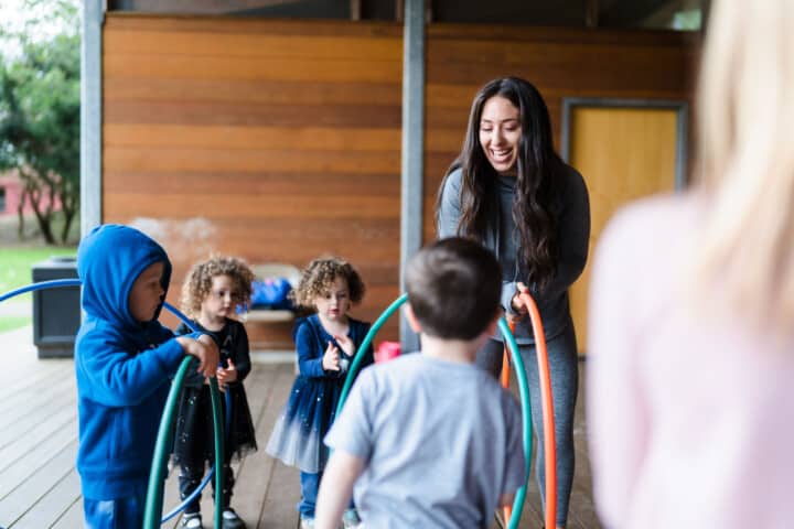 Kids playing with hula hoops in a modern dance class.