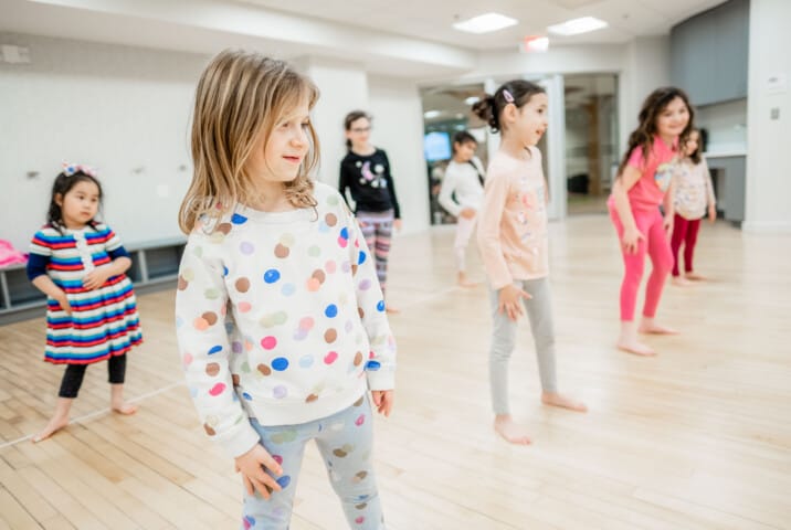 Kids taking a dance class.