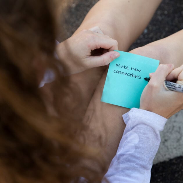 Peer Leadership Fellow writing a note.