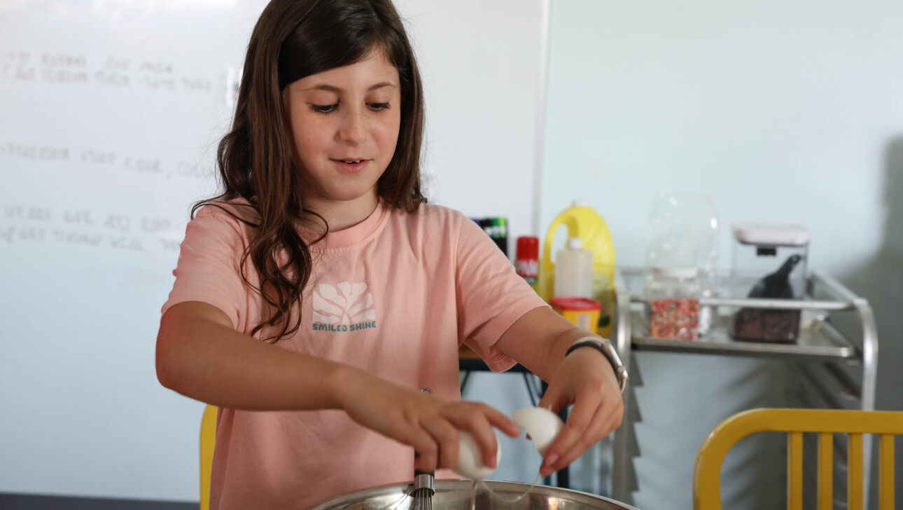 Girl cooking at camp.