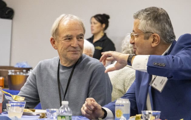 Two men talking at a Boston Israeli Film Series reception.