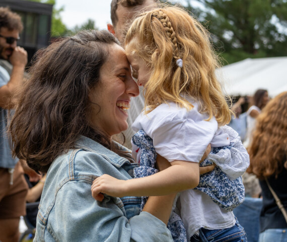 Godine student and mother hugging at graduation.